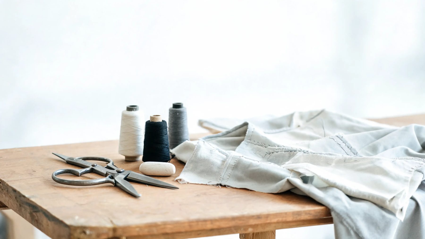 Workroom bench with shears, chalk and thread